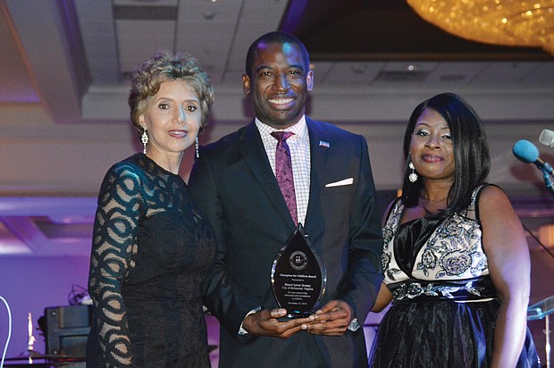 Mayor Levar M. Stoney shows off the “Champion for Children” Award he received from the Richmond Chapter of The Continental Societies at the group’s Dec. 21 fundraising dinner-dance in Downtown. With him are Beverly Davis, left, chair of the organization’s Ways and Means Committee, and Nkechi George-Winkler, president of the Richmond chapter.