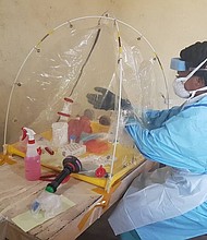 A lab worker at a mobile lab set up inside Beni Reference Hospital to analyze and test samples from suspected Ebola cases on August 3.