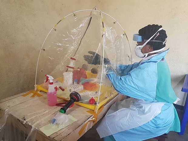 A lab worker at a mobile lab set up inside Beni Reference Hospital to analyze and test samples from suspected Ebola cases on August 3.