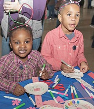 Ringing in the new year: Confetti rains down on 2,500 youngsters and their families gathered at the Science Museum of Virginia to ring in 2019 early — at noon on Monday. Youngsters, including Aleyah Michael, 4, left, and Brycen Woodson, 5, made wearable decorations for the “Noon Year’s Eve” celebration, which featured a giant party ball, music, countdown, noisemakers and a parade. Youngsters also could sign a huge banner with their resolutions for 2019. (Photo by Ava Reaves)