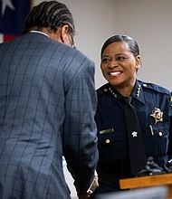 Dallas County Commissioner John Wiley Price shakes hands with Sheriff Marian Brown after swearing her in as sheriff.