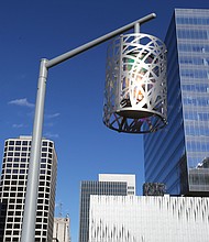 This stylish and decorative streetlight, set against the backdrop of the Richmond skyline, stands in Kanawha Plaza, the city park at 8th and Canal streets in Downtown. The look is part of a $2.9 million makeover completed in 2016 for the park, which previously was an informal shelter for the homeless. The previous traditional globe streetlights often were broken. The Enrichmond Foundation is in charge of fundraising for the park to cover the cost of maintenence and events. (Regina H. Boone/Richmond Free Press)