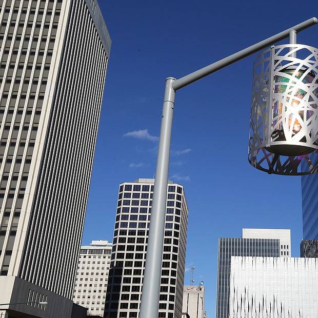 This stylish and decorative streetlight, set against the backdrop of the Richmond skyline, stands in Kanawha Plaza, the city park at 8th and Canal streets in Downtown. The look is part of a $2.9 million makeover completed in 2016 for the park, which previously was an informal shelter for the homeless. The previous traditional globe streetlights often were broken. The Enrichmond Foundation is in charge of fundraising for the park to cover the cost of maintenence and events. (Regina H. Boone/Richmond Free Press)