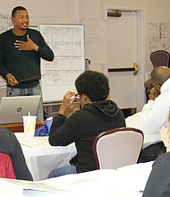 Micah White with CARITAS Works leads a recent training session on customer service and personal development at Cedar Street Baptist Church of God.
