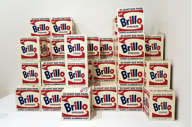 Andy Warhol’s “Brillo Boxes” on display at the Whitney Museum. Each box contains the OU kosher symbol, shown above, in the bottom left corner above the word “Shines.”