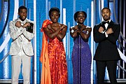 Golden Globe Award presenters, from left, Chadwick Boseman, Danai Gurira, Lupita Nyoung’o and Michael B. Jordan give the “Wakanda salute” from their box office hit “Black Panther” during the Sunday ceremony. The film and several of the actors were nominated for awards, but went home empty-handed.