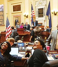 New General Assembly session
Petersburg Delegate Lashrecse D. Aird and her seatmate, Newport News Delegate Marcia S. Price, look up as a person in the upstairs gallery takes their photo. Looking on is Delegate Luke E. Torian of Prince William County. Scenes like this were commonplace Wednesday as the General Assembly opened its 2019 session, which is expected to run about 46 days. Legislators, whose seats will be up for election in November, will be rushing during the short session to get through a sea of bills and amend the current two-year budget before adjourning in late February. (Regina H. Boone/Richmond Free Press)