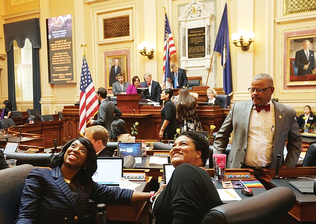 New General Assembly session
Petersburg Delegate Lashrecse D. Aird and her seatmate, Newport News Delegate Marcia S. Price, look up as a person in the upstairs gallery takes their photo. Looking on is Delegate Luke E. Torian of Prince William County. Scenes like this were commonplace Wednesday as the General Assembly opened its 2019 session, which is expected to run about 46 days. Legislators, whose seats will be up for election in November, will be rushing during the short session to get through a sea of bills and amend the current two-year budget before adjourning in late February. (Regina H. Boone/Richmond Free Press)