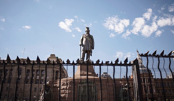 A hulking statue of a late 19th century white leader, with a cane and top hat, has been a flashpoint ...