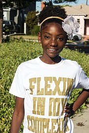 12-Year Old Kheris Rogers poses in her Flexin' In My Complexion T-Shirt