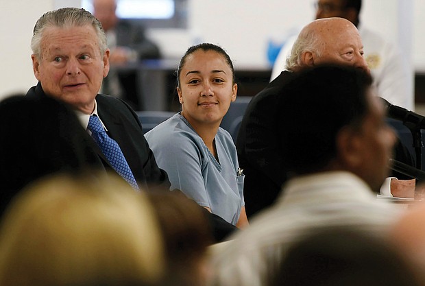 Cyntoia Brown smiles at family members during a May 2018 clemency hearing at Tennessee Prison for Women in Nashville. She was serving a life sentence for killing a man in 2004 when she was a 16-year-old sex trafficking victim.