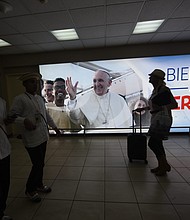 A sign with a photo of Pope Francis, reading "Welcome to Panama, Pilgrims," at the Tocumen airport ahead of World Youth Day.