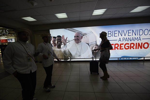 A sign with a photo of Pope Francis, reading "Welcome to Panama, Pilgrims," at the Tocumen airport ahead of World Youth Day.