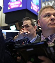 Stocks fell Tuesday after a series of economic reports confirmed what investors have feared: The global economy's long rebound could be nearing its end.