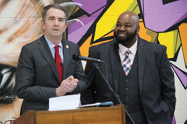Gov. Ralph S. Northam, left, surprises Richmond teacher Rodney A. Robinson Wednesday by announcing his selection as a finalist for the National Teacher of the Year. Location: Virgie Binford Education Center at the Richmond Juvenile Detention Center, where Mr. Robinson teaches history and social studies.