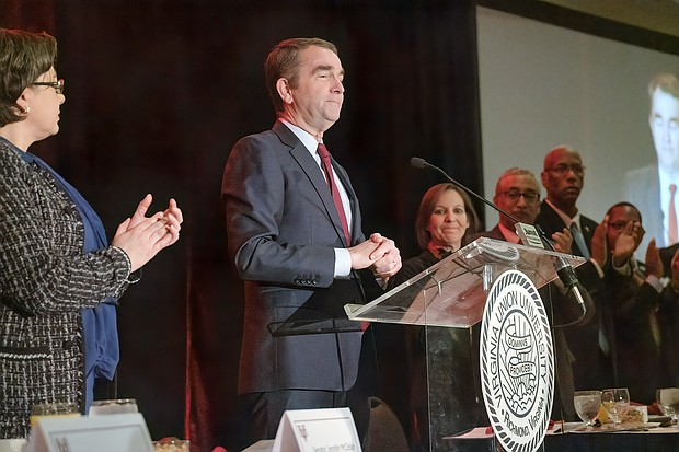 Gov. Ralph S. Northam urges people to follow Dr. Martin Luther King Jr.’s lead and become vocal “about things that matter” at the annual Community Leaders Breakfast last Friday celebrating the civil rights icon. Left, Richmond state Sen. Jennifer L. McClellan joins in applauding the governor after introducing him.