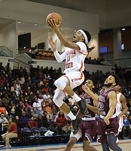 Virginia State University’s Cyonte Melvin goes airborne to the rim during last Saturday’s Freedom Classic at the VSU Multi-Purpose Center.