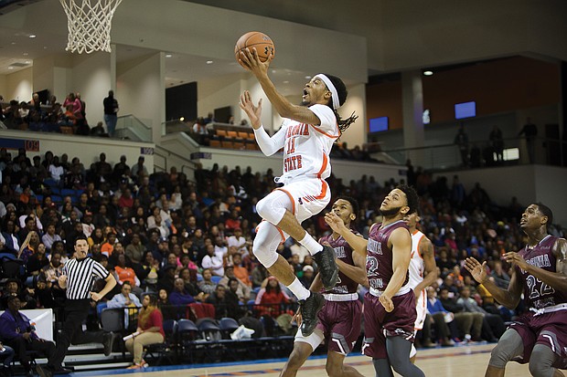 Virginia State University’s Cyonte Melvin goes airborne to the rim during last Saturday’s Freedom Classic at the VSU Multi-Purpose Center.