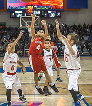 Future big-time ballers: Third- and fourth-graders from Team Richmond Garner Road give it their all during a scrimmage at halftime of the women’s game at the annual Freedom Classic last Saturday held at the Virginia State University Multi-Purpose Center in Ettrick. Please see coverage of the Freedom Classic, A8.