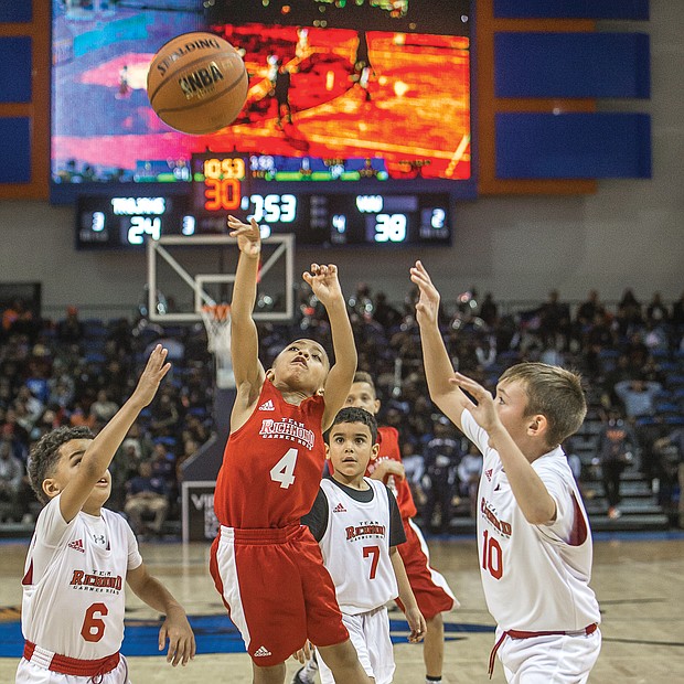 Future big-time ballers: Third- and fourth-graders from Team Richmond Garner Road give it their all during a scrimmage at halftime of the women’s game at the annual Freedom Classic last Saturday held at the Virginia State University Multi-Purpose Center in Ettrick. Please see coverage of the Freedom Classic, A8.