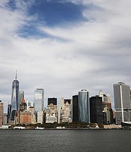 The Manhattan skyline  towers over New York harbor on October 16, 2017 in New York City.