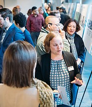 METRO staff members explain features of Moving Forward Plan at a METRONext public meeting.