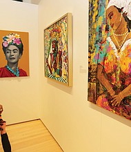 Patricia Lancaster of Chesterfield County browses the work on view at “The Art of Freedom” exhibit at the Black History Museum & Cultural Center in Jackson Ward. The exhibit, which is on view through May 19, includes more than 60 works in various mediums by 36 African-American artists born or living in Virginia who express their meaning of freedom.