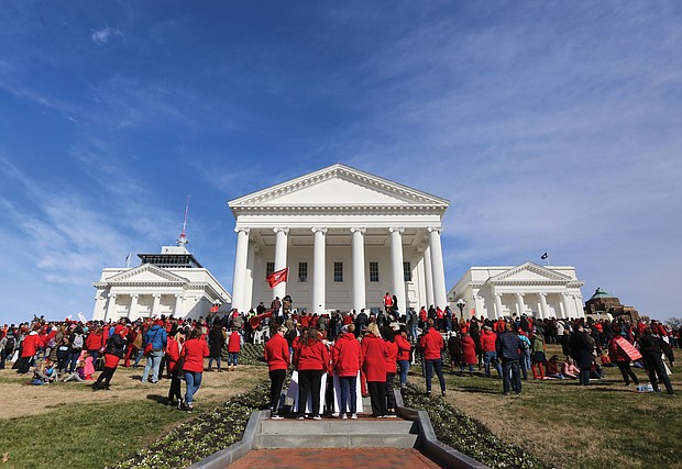 Thousands of teachers, parents, students, administrators, elected officials and education supporters gather Monday at the State Capitol after a march from Monroe Park to demand more money for public education in Virginia. The event was part of Virginia Educators United’s #RedforEd campaign.