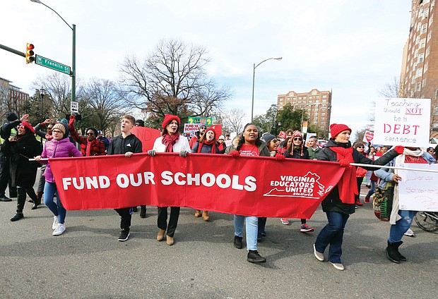Marching for education: People of all ages wearing red hats, scarves, jackets and shirts signal their support for more state money for public education in Virginia during Monday’s #RedforEd march and rally from Monroe Park to the State Capitol. State lawmakers meeting at the General Assembly session said they will support a 5 percent pay hike for Virginia’s teachers. (Regina H. Boone/Richmond Free Press)