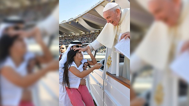A little girl evaded tight police security inside Abu Dhabi's city stadium and ran to Pope Francis to deliver him a letter.