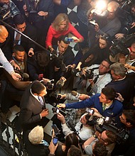 Lt. Gov. Justin E. Fairfax, center, is swarmed by reporters Monday inside the Capitol Rotunda as he responds to an allegation that he sexually assaulted a woman in 2004. He has denied the allegation.