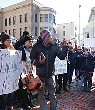 Protesters gather outside the Executive Mansion on Saturday morning demanding the resignation of Gov. Ralph S. Northam.