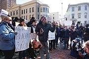 Protesters gather outside the Executive Mansion on Saturday morning demanding the resignation of Gov. Ralph S. Northam.