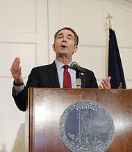 Gov. Ralph S. Northam backpedals during a news conference at the Executive Mansion on Saturday, saying that he is not either of the two people in the racist photo that was published on his 1984 Eastern Virginia Medical School yearbook page. Standing by his side is his wife, First Lady Pam Northam.
