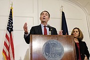 Gov. Ralph S. Northam backpedals during a news conference at the Executive Mansion on Saturday, saying that he is not either of the two people in the racist photo that was published on his 1984 Eastern Virginia Medical School yearbook page. Standing by his side is his wife, First Lady Pam Northam.