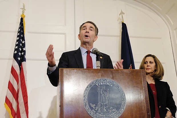 Gov. Ralph S. Northam backpedals during a news conference at the Executive Mansion on Saturday, saying that he is not either of the two people in the racist photo that was published on his 1984 Eastern Virginia Medical School yearbook page. Standing by his side is his wife, First Lady Pam Northam.