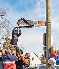 It’s a family affair: When the string didn’t work on Sunday to unveil the honorary North Side street sign for the late Clarence L. Townes Jr., Townes family members and friends lifted Mr. Townes’ great-grandson, 8-year-old Ryland Willis, to remove the sign’s covering. A crowd turned out for the honor to the late Richmond business and civic leader who also was chairman of the Richmond School Board for four years. He died in January 2017. Below, the Townes family stands by the sign located at the intersection of Ladies Mile Road and the 3100 block of Hawthorne Avenue.  (Ava Reaves)