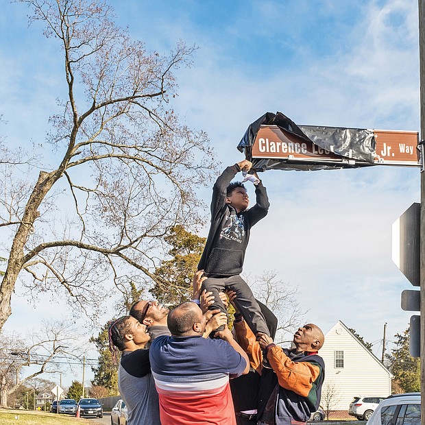 It’s a family affair: When the string didn’t work on Sunday to unveil the honorary North Side street sign for the late Clarence L. Townes Jr., Townes family members and friends lifted Mr. Townes’ great-grandson, 8-year-old Ryland Willis, to remove the sign’s covering. A crowd turned out for the honor to the late Richmond business and civic leader who also was chairman of the Richmond School Board for four years. He died in January 2017. Below, the Townes family stands by the sign located at the intersection of Ladies Mile Road and the 3100 block of Hawthorne Avenue.  (Ava Reaves)
