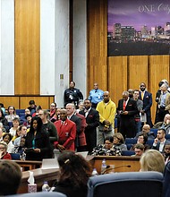 A long line of people wait their turn to speak before Richmond City Council Monday night on renaming the street Arthur Ashe Boulevard.
