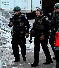 Law enforcement officers work at the scene of a shooting at the Henry Pratt Co. on Friday, Feb. 15, 2019, in Aurora, Ill.