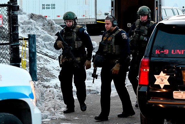 Law enforcement officers work at the scene of a shooting at the Henry Pratt Co. on Friday, Feb. 15, 2019, in Aurora, Ill.