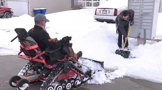 Iraq war veteran and teen next door partner up to remove neighborhood snow.