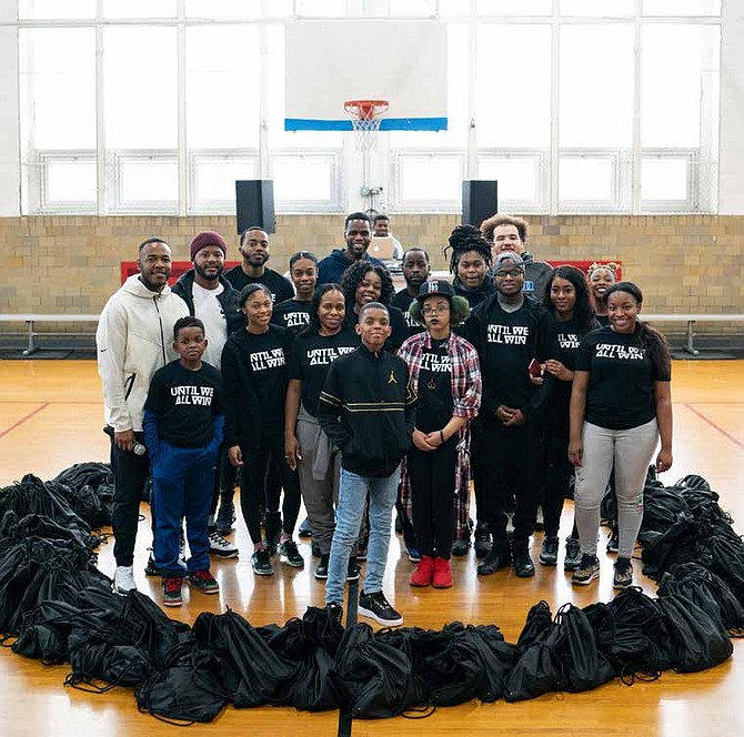 11-year-old Jahkil Jackson, founder of Project I Am, (center) recently partnered with Nike to celebrate Black History Month by hosting a community service day. Photo Credit: Nike Chicago