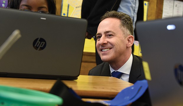 Richmond Superintendent Jason Kamras finishes a recent day visiting 12 schools by watching a student work on a laptop at Barack Obama Elementary School.