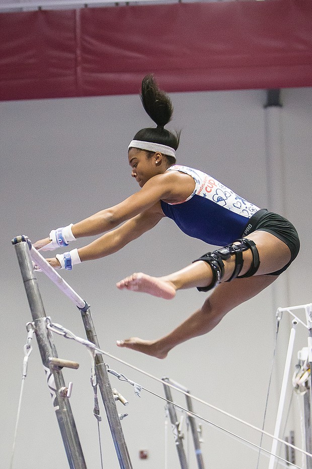 Left, Chesterfield County athlete Elexis ‘Lexi’ Edwards shows her gymnastic skills on the uneven bars.