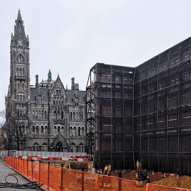 Work is underway at 9th and Broad streets on a new 15-story office building for members of the General Assembly. The previous General Assembly Building, as it was called, was torn down last year, with only the historic 1912 façade saved for incorporation into the new building. The façade is being held in place with metal scaffolding. The new building is expected to be completed in 2021. About $300 million is being invested in the new construction and in the renovation of Old City Hall, seen in the background. For now, General Assembly members have offices in temporary quarters in the Pocahontas Building on Main Street. (Sandra Sellars/Richmond Free Press)