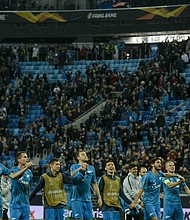 Zenit St. Petersburg's players celebrate after round-of-32 win.