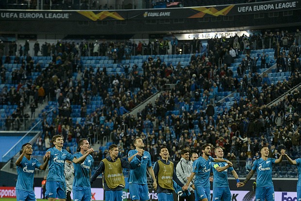 Zenit St. Petersburg's players celebrate after round-of-32 win.