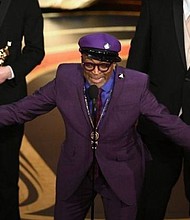 Spike Lee accepts the Oscar for adapted screenplay for “BlacKkKlansman.” (Kevin Winter / Getty Images)