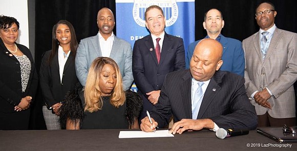 Lois Johnson, ceo and founder of of Salt Lake City, Utah-based United Security Financial (USF) and NAREB president Jeffrey Hicks(Front) …